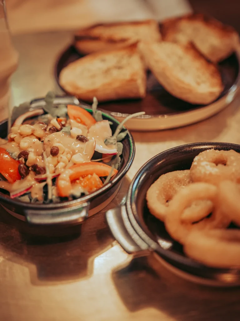 The meal served in a pub in Stirling on August 16, 2026: mixed salad, onion rings, and toasted bread. Neither the establishment nor the menu are documented in the