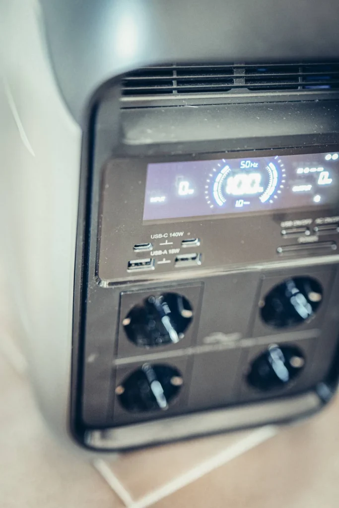 Close-up of the ALLPOWERS P1800 power station showing its integrated control screen, the four AC outlets, the two USB-C ports, and the two USB-A ports on the front.