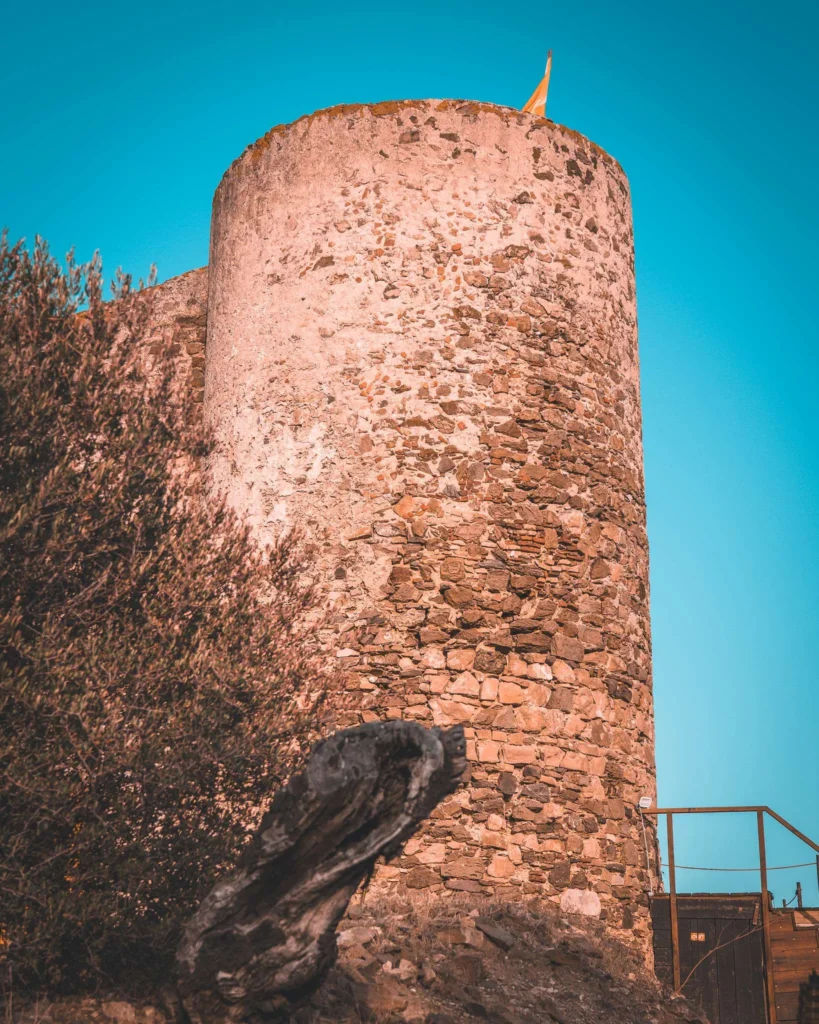 Stone tower of a medieval castle under a blue sky, probably in Castro Marim during the medieval festival in the Algarve.